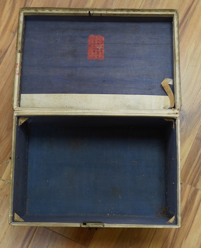 A vellum bound trunk, Chinese label to interior, 42cm wide, 24.5cm high. Condition - poor